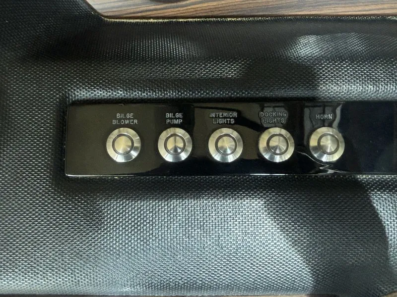 Slide: The Image of Control panel of a 2014 Cobalt A25 boat with labeled buttons. - 15