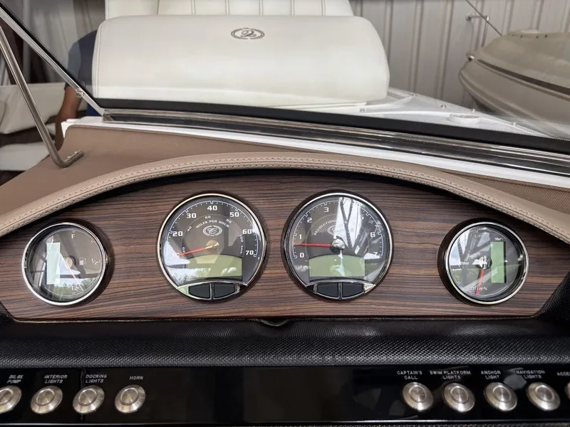 Slide: The Image of Dashboard of a 2014 Cobalt A25 boat with gauges and control buttons. - 16