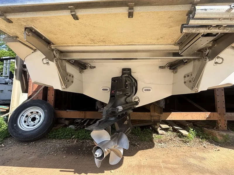 Slide: The Image of 2014 Cobalt A25 boat stern with propeller and trailer wheel visible. - 25