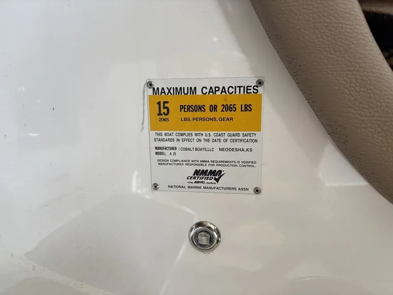 Slide: The Image of 2014 Cobalt A25 capacity label, maximum 15 persons or 2065 lbs, NMMA certified. - 26