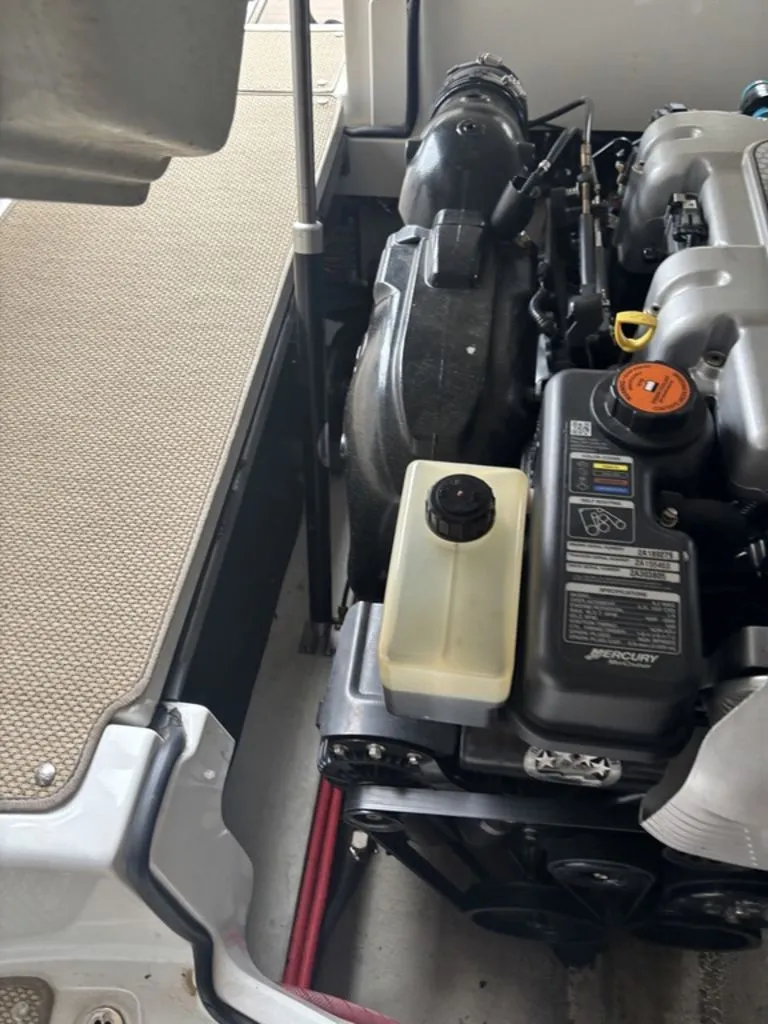 Slide: The Image of Engine compartment of a 2014 Cobalt A25 boat, featuring Mercury components. - 27