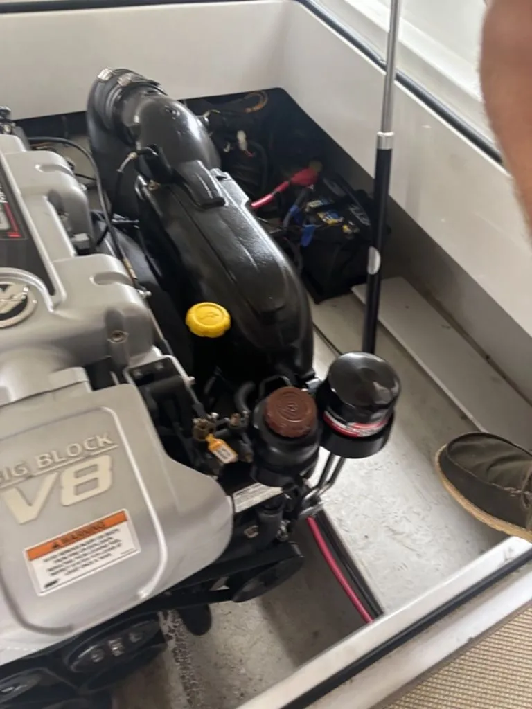 Slide: The Image of 2014 Cobalt A25 boat engine compartment with V8 engine and battery visible. - 28