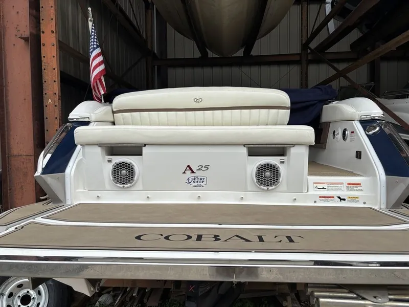 Slide: The Image of 2014 Cobalt A25 boat with American flag, docked in storage facility. - 5