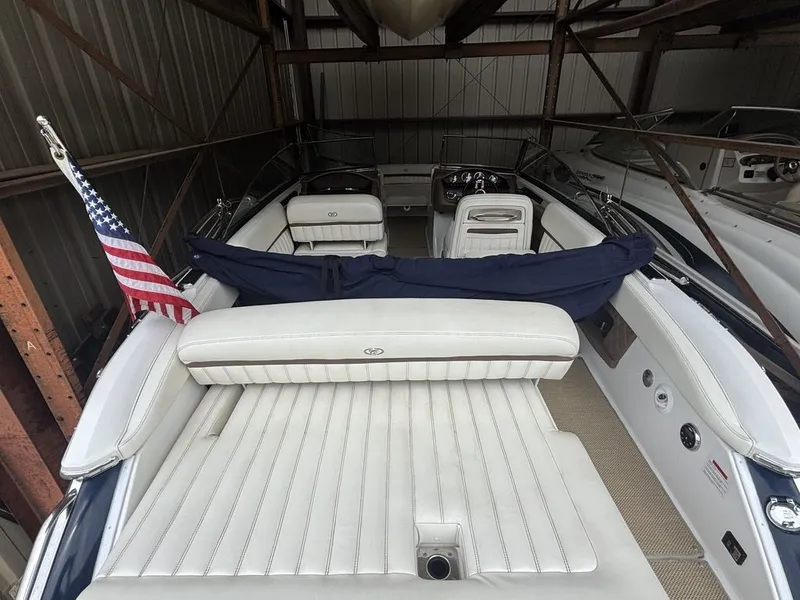 Slide: The Image of 2014 Cobalt A25 boat with white seating, American flag, stored indoors. - 6