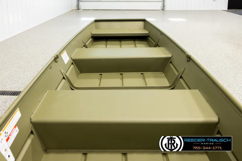 Slide: The Image of 2026 Lund 1040 boat interior with bench seats in a showroom. - 11