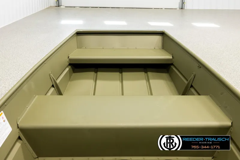 Slide: The Image of 2026 Lund 1040 boat interior with bench seats in a showroom. - 12