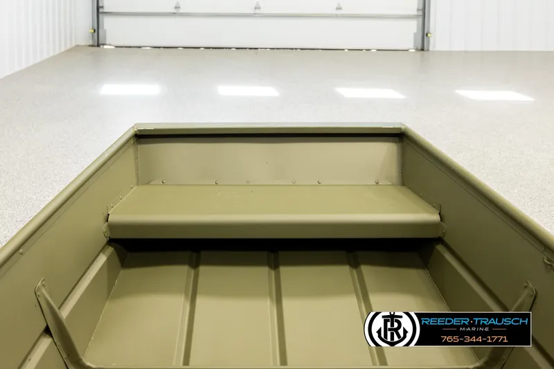 Slide: The Image of 2026 Lund 1040 boat interior in a showroom with Reeder-Trausch Marine logo. - 13