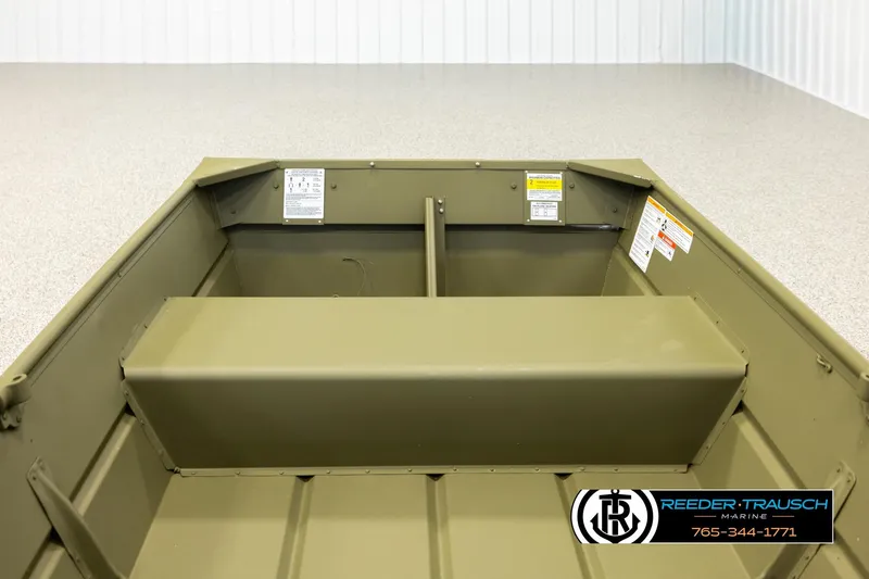 Slide: The Image of 2026 Lund 1040 boat interior with bench seat and safety labels. - 16