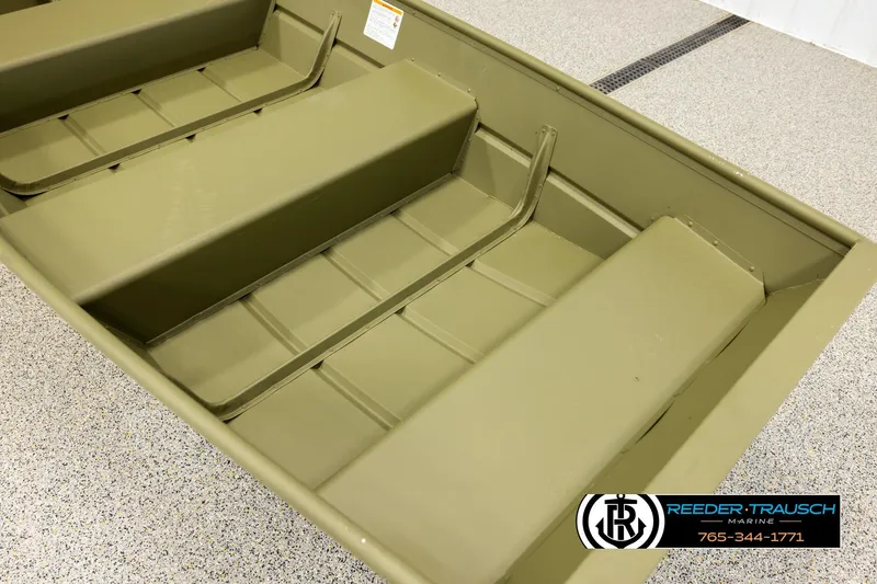 Slide: The Image of 2026 Lund 1040 boat interior with bench seats, displayed on a showroom floor. - 7