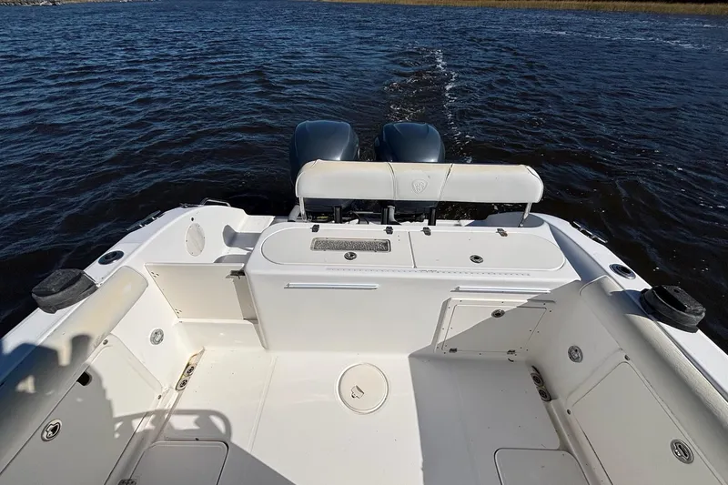 Slide: The Image of 2006 Century 2600 Center Console boat on water, featuring dual engines and spacious deck. - 10