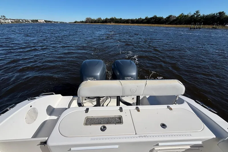 Slide: The Image of 2006 Century 2600 Center Console boat with dual Yamaha engines on a calm river. - 11