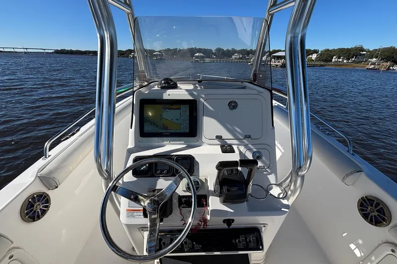 Slide: The Image of 2006 Century 2600 Center Console boat dashboard with steering wheel and navigation system. - 14