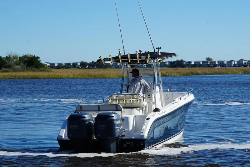 Slide: The Image of 2006 Century 2600 Center Console boat cruising on a calm river. - 3