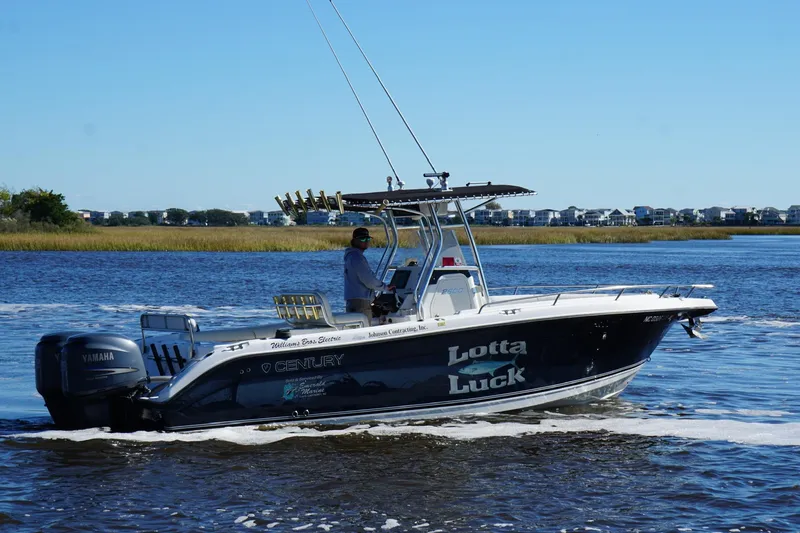 Slide: The Image of Century 2600 Center Console boat cruising on water, 2006 model, with Yamaha engine. - 4