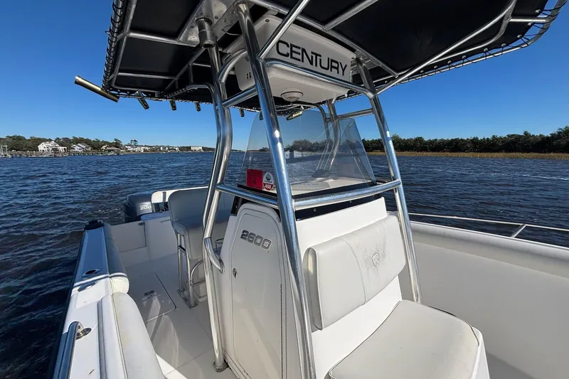 Slide: The Image of 2006 Century 2600 Center Console boat on water, featuring sleek design and spacious seating. - 8