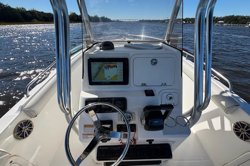 Slide: The Image of 2006 Century 2600 Center Console boat dashboard with navigation system on open water. - 9