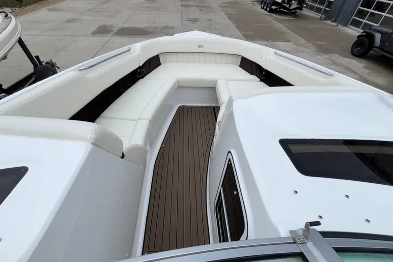 Slide: The Image of 2022 Cobalt R35 boat interior with white seating and wooden flooring. - 20