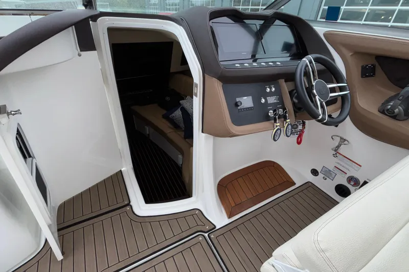 Slide: The Image of 2022 Cobalt R35 boat interior with helm, steering wheel, and cabin entrance. - 21