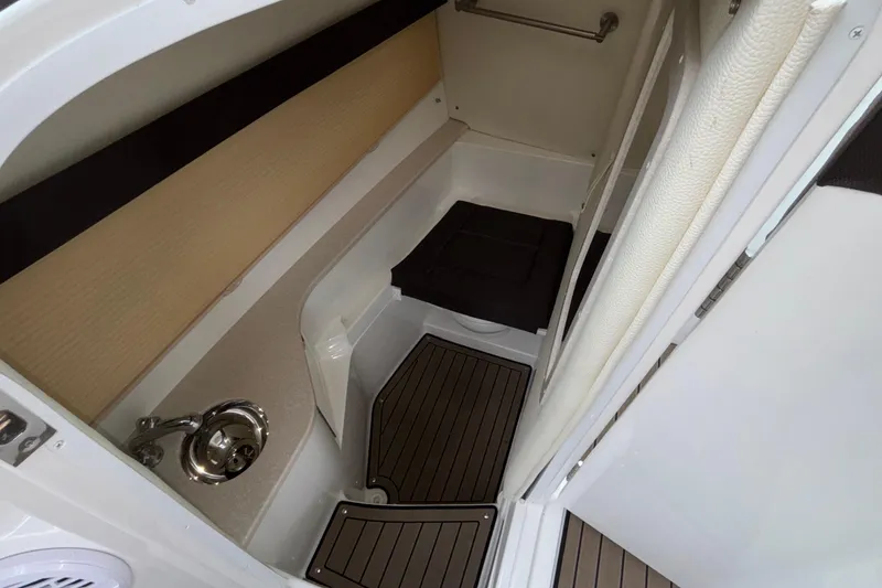 Slide: The Image of 2022 Cobalt R35 boat interior with compact bathroom and sink. - 26
