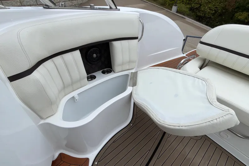 Slide: The Image of 2022 Cobalt R35 boat interior with white seating and foldable table. - 31