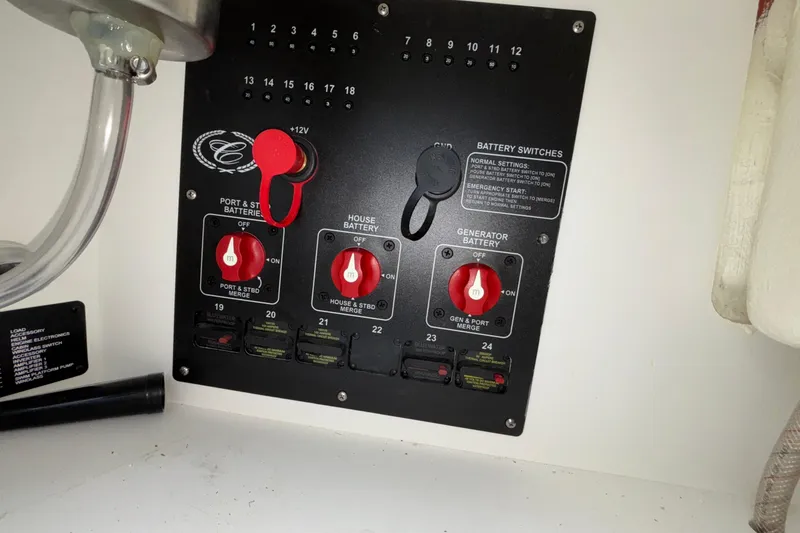 Slide: The Image of Battery switch panel in a 2022 Cobalt R35 boat, featuring multiple control knobs. - 33