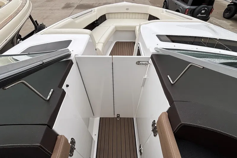 Slide: The Image of 2022 Cobalt R35 boat interior with white seating and brown flooring. - 38