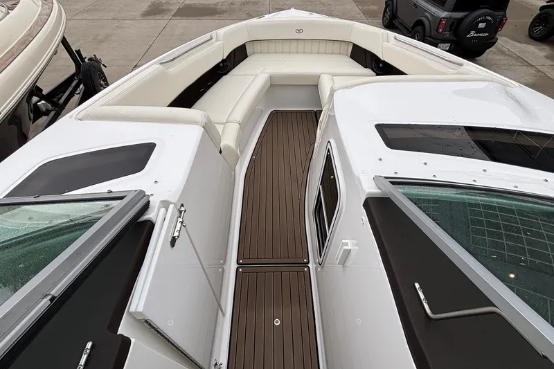 Slide: The Image of 2022 Cobalt R35 boat with white seating and brown deck, parked outdoors. - 39