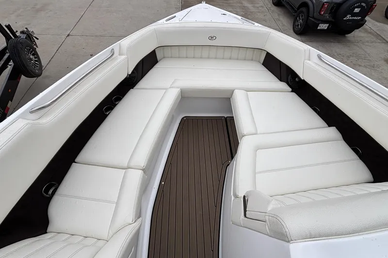 Slide: The Image of 2022 Cobalt R35 boat interior with white seating and brown flooring. - 42