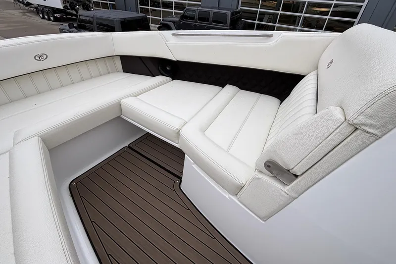 Slide: The Image of Luxurious seating on 2022 Cobalt R35 boat with white upholstery and wood-style flooring. - 43