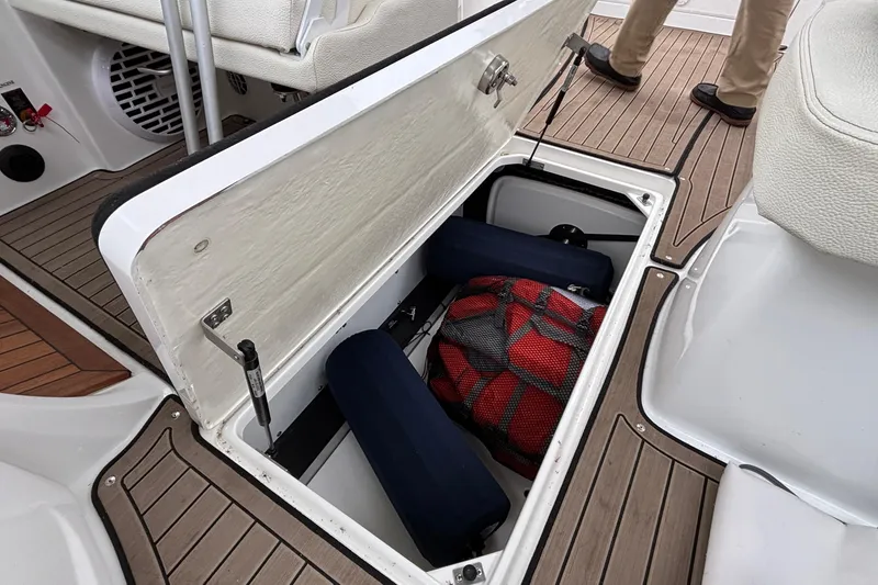 Slide: The Image of Cobalt R35 2022 boat storage compartment with life jackets and gear on deck. - 53