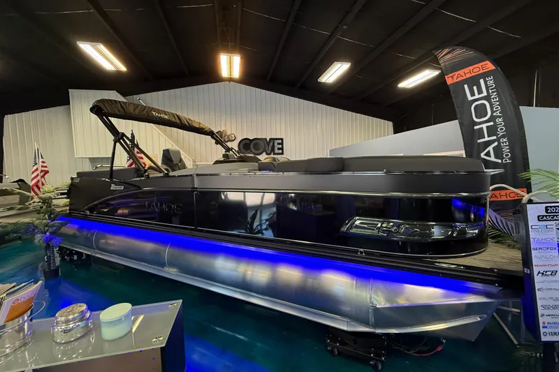 The Image of 2026 Tahoe Pontoon Cascade Cruise Rear Bench displayed indoors with blue underglow lighting. - 1
