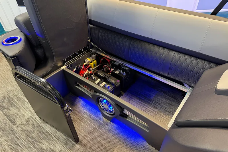 Slide: The Image of 2026 Tahoe Pontoon Cascade Cruise Rear Bench with open storage and illuminated interior. - 14