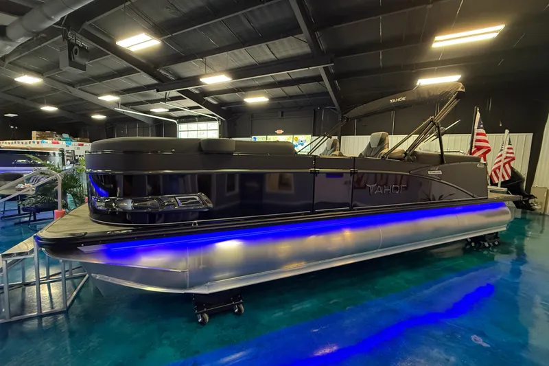 Slide: The Image of 2026 Tahoe Pontoon Cascade Cruise Rear Bench with blue LED lights in showroom. - 15