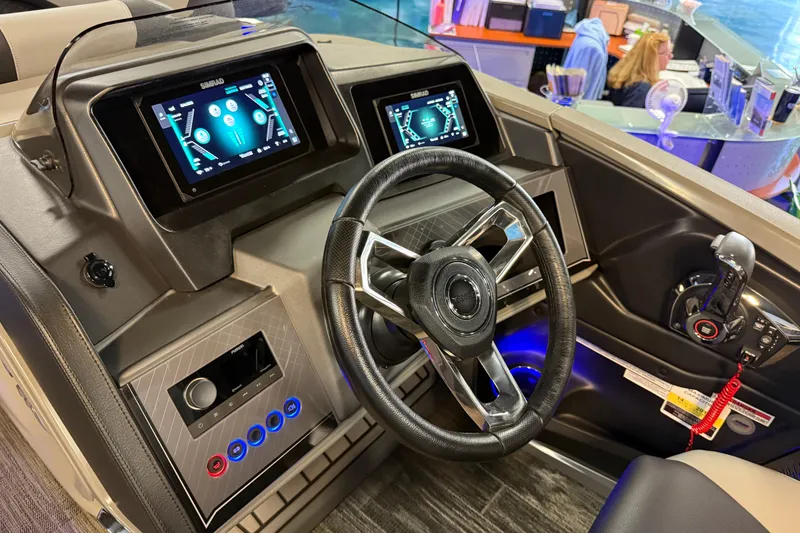 Slide: The Image of 2026 Tahoe Pontoon Cascade Cruise Rear Bench dashboard with modern controls and steering wheel. - 8