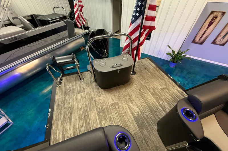 Slide: The Image of 2026 Tahoe Pontoon Cascade Cruise Rear Bench with American flags in showroom. - 9
