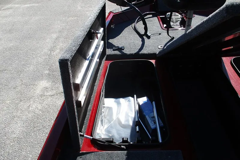 Slide: The Image of 2026 Ranger RT188P Fishing boat storage compartment with open lid and equipment inside. - 12