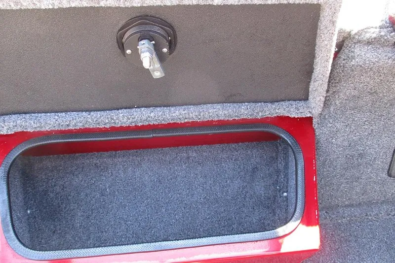 Slide: The Image of 2026 Ranger RT188P Fishing boat storage compartment with latch, carpeted interior. - 17