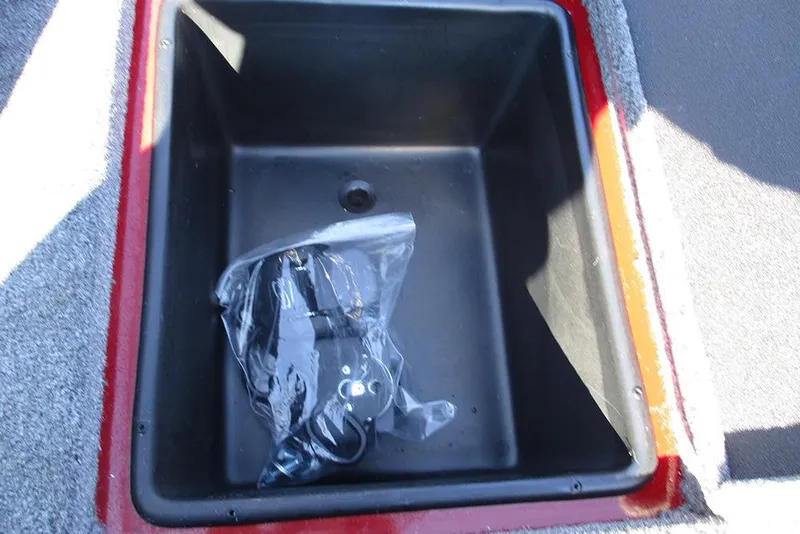 Slide: The Image of Storage compartment of 2026 Ranger RT188P Fishing boat with plastic-wrapped accessories. - 24