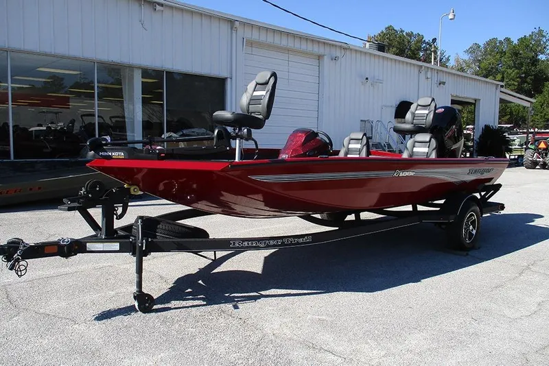Slide: The Image of 2026 Ranger RT188P Fishing boat in red on a trailer outside a building. - 3