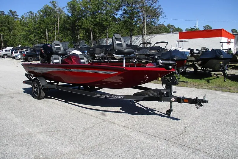 Slide: The Image of 2026 Ranger RT188P Fishing boat in vibrant red on a trailer, parked outdoors. - 5