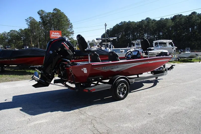 Slide: The Image of 2026 Ranger RT188P Fishing boat in a parking lot, featuring a sleek red design. - 7