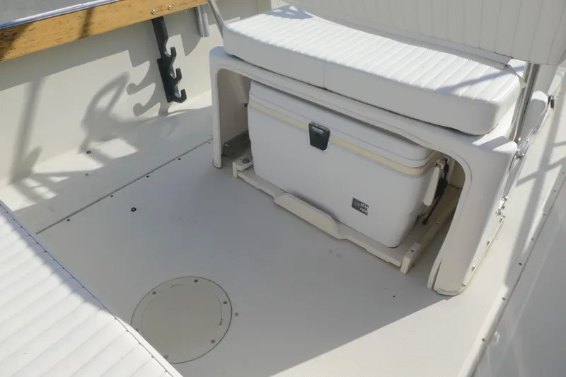 Slide: The Image of 1989 Boston Whaler 220 Outrage interior with seating and storage area. - 11