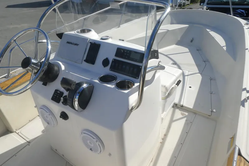 Slide: The Image of 1989 Boston Whaler 220 Outrage boat console with steering wheel and controls. - 12