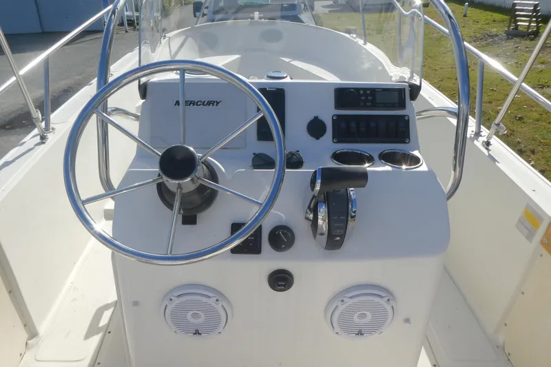 Slide: The Image of 1989 Boston Whaler 220 Outrage boat console with steering wheel and controls. - 5