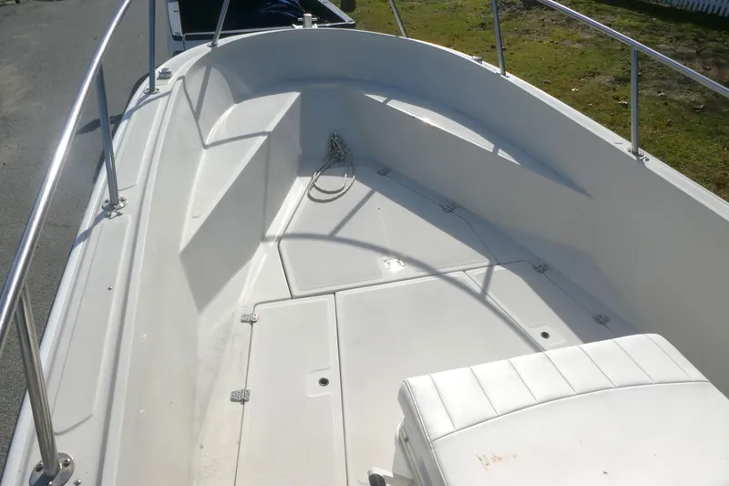 Slide: The Image of 1989 Boston Whaler 220 Outrage boat interior with white seating and railings. - 6