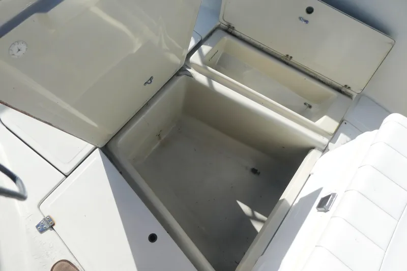 Slide: The Image of Open storage compartments on a 1989 Boston Whaler 220 Outrage boat. - 8