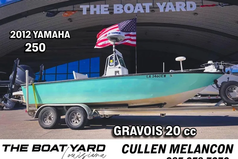 Slide: The Image of 1997 Gravois 20CC boat on trailer at The Boat Yard, American flag displayed. - 1