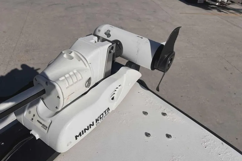 Slide: The Image of 1997 Gravois 20CC boat interior with console and seating, docked on concrete surface. - 15