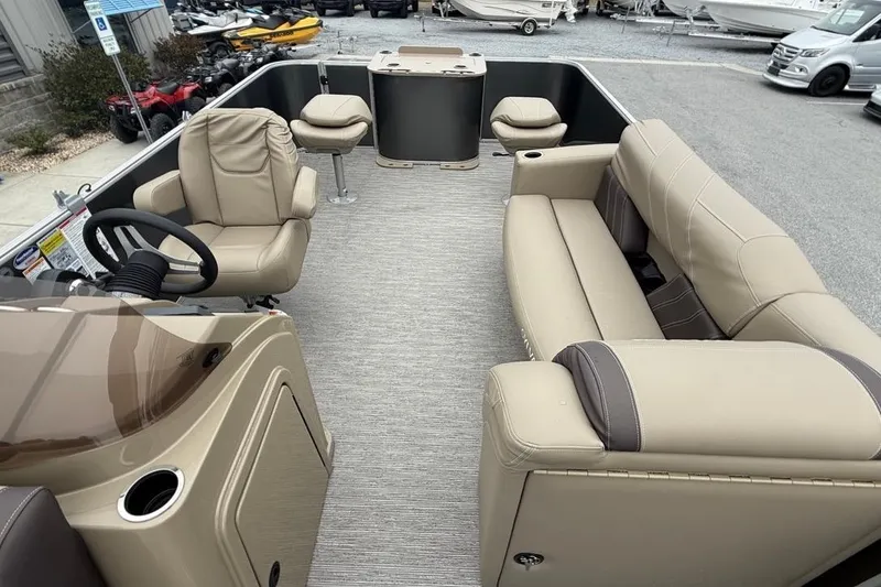 Slide: The Image of 2026 Sylvan Mirage 822 PARTY FISH pontoon boat interior with beige seating and steering console. - 15