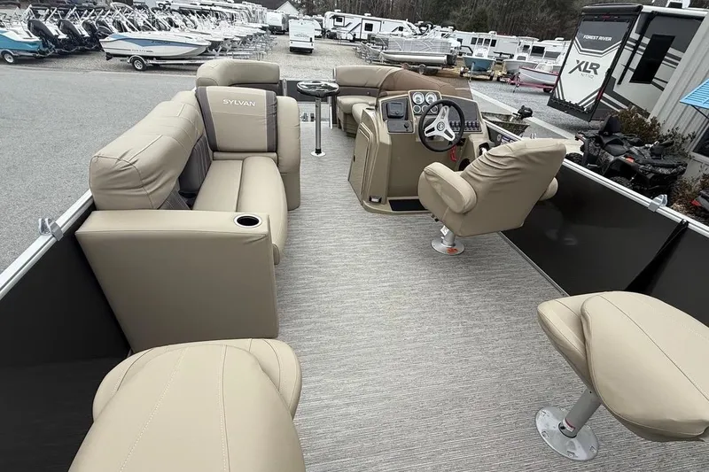 Slide: The Image of 2026 Sylvan Mirage 822 PARTY FISH pontoon boat interior with beige seating and helm. - 16